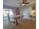 Cozy dining room with access to the backyard, complemented by a ceiling fan and natural light at 218 Omaha St S S St, Lake Hamilton, FL 33851