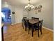 Inviting dining room with chandelier lighting, wood flooring, and seating for six at 218 Omaha St S S St, Lake Hamilton, FL 33851