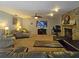 Comfortable living room featuring plush seating, a fireplace, and a ceiling fan at 218 Omaha St S S St, Lake Hamilton, FL 33851