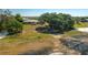 Aerial view of a lakefront property with a spacious yard, mature trees, and access to water at 225 Wes Mann Rd, Babson Park, FL 33827