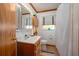 Bathroom with single vanity sink, tiled floors, toilet, and shower with white shower curtain at 225 Wes Mann Rd, Babson Park, FL 33827