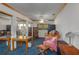 Bedroom includes a desk, bookshelves, ceiling fan, and blue carpet at 225 Wes Mann Rd, Babson Park, FL 33827