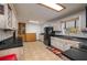 Open kitchen with light wood cabinets, black countertops, and modern appliances at 225 Wes Mann Rd, Babson Park, FL 33827