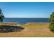 Scenic view of the serene lake with clear blue waters, trees, and marshy shoreline at 225 Wes Mann Rd, Babson Park, FL 33827
