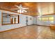 Spacious living room featuring tile floors, wood ceiling, and a large decorative mirror at 225 Wes Mann Rd, Babson Park, FL 33827