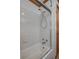 A white bathtub with a white tiled surround and sliding glass shower door at 225 Wes Mann Rd, Babson Park, FL 33827