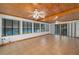 Bright sunroom with wood ceiling, tiled floor, and plenty of windows to let the light in at 225 Wes Mann Rd, Babson Park, FL 33827
