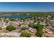 Aerial view of a cozy community with mature trees surrounding a beautiful lake at 23 Kendra Ct, Winter Haven, FL 33880