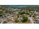 Aerial view showcasing the community, mature trees, and nearby lake at 23 Kendra Ct, Winter Haven, FL 33880