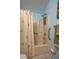 Bathroom features a shower with a floral curtain and a grab bar for easy access at 23 Kendra Ct, Winter Haven, FL 33880