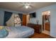 Bedroom featuring hardwood floors, blue walls, and a door to a screened-in patio at 23 Kendra Ct, Winter Haven, FL 33880