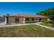 Well-maintained exterior featuring lush landscaping and manicured lawn at 23 Kendra Ct, Winter Haven, FL 33880