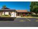 Well-maintained exterior with mature landscaping, a covered parking space, and community visitor parking at 23 Kendra Ct, Winter Haven, FL 33880