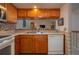 This kitchen includes a dishwasher and oak cabinets at 23 Kendra Ct, Winter Haven, FL 33880