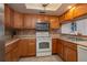 This kitchen includes a microwave and oak cabinets at 23 Kendra Ct, Winter Haven, FL 33880