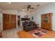 Cozy living room with tile and wood flooring, a ceiling fan, and direct access to the kitchen at 23 Kendra Ct, Winter Haven, FL 33880