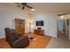 Cozy living room features wood floors, entertainment center, and comfortable seating at 23 Kendra Ct, Winter Haven, FL 33880