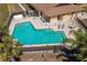 Community pool featuring a modern design with shaded seating area at 23 Kendra Ct, Winter Haven, FL 33880
