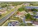 An aerial view of a house with a pool near a long roadway and small lake at 247 Cobalt Dr, Kissimmee, FL 34758