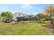 A wide shot of the backyard featuring a screened-in pool, shed and lush green grass at 247 Cobalt Dr, Kissimmee, FL 34758
