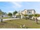Beautiful two-story home with a two-car garage, long driveway, and lush green lawn with tropical landscaping at 247 Cobalt Dr, Kissimmee, FL 34758