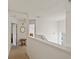 Bright hallway with an open floor plan, white walls, carpet, and a small table with decor at 247 Cobalt Dr, Kissimmee, FL 34758