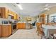 An open-concept kitchen with stainless steel appliances, wood cabinets, and dining area are showcased in this home at 247 Cobalt Dr, Kissimmee, FL 34758