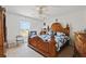 Large main bedroom with a decorative wooden bed frame and window at 247 Cobalt Dr, Kissimmee, FL 34758