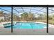 A backyard pool with a screened-in enclosure, spa, and space for outdoor seating and entertaining at 247 Cobalt Dr, Kissimmee, FL 34758