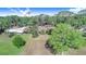 Aerial view of the expansive home and property, surrounded by mature trees and lush greenery for ultimate privacy at 2750 W Lake Hamilton Dr, Winter Haven, FL 33881