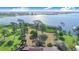 Gorgeous lakefront lot with mature trees and direct lake access, with house in the foreground at 2750 W Lake Hamilton Dr, Winter Haven, FL 33881