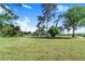 Spacious backyard with well-maintained grass and mature trees at 2750 W Lake Hamilton Dr, Winter Haven, FL 33881