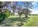 Lush backyard featuring mature trees and well-maintained grass at 2750 W Lake Hamilton Dr, Winter Haven, FL 33881