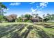 Large backyard with a mix of sun and shade under the blue sky at 2750 W Lake Hamilton Dr, Winter Haven, FL 33881