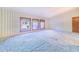 Large bedroom features three windows providing natural light, carpet, and patterned wallpaper at 2750 W Lake Hamilton Dr, Winter Haven, FL 33881