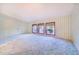 Spacious bedroom featuring patterned wallpaper, plush carpeting, and natural light from three windows at 2750 W Lake Hamilton Dr, Winter Haven, FL 33881