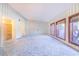Bright bedroom with plush carpeting, patterned wallpaper, closet, and natural light from three windows at 2750 W Lake Hamilton Dr, Winter Haven, FL 33881