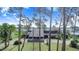 Exterior of the home with a unique carport design surrounded by trees at 2750 W Lake Hamilton Dr, Winter Haven, FL 33881
