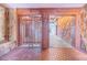 Unique foyer with brick floors, wood trim, stone accent wall, and a decorative wood gate, creating a distinctive architectural design at 2750 W Lake Hamilton Dr, Winter Haven, FL 33881