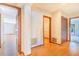 Bright hallway features wood floors, multiple doorways and textured wallpaper at 2750 W Lake Hamilton Dr, Winter Haven, FL 33881