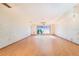 Large living room featuring hardwood floors and a large picture window with tree top views at 2750 W Lake Hamilton Dr, Winter Haven, FL 33881
