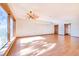 Spacious living room featuring hardwood floors, ceiling fan, and an abundance of natural light at 2750 W Lake Hamilton Dr, Winter Haven, FL 33881