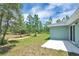 The backyard offers green grass with plenty of room to roam at 3120 Oleander Dr, Indian Lake Estates, FL 33855