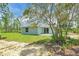 The backyard features a large green lawn and space for entertainment at 3120 Oleander Dr, Indian Lake Estates, FL 33855