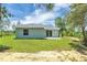 The home features a sprawling lawn, perfect for outdoor activities at 3120 Oleander Dr, Indian Lake Estates, FL 33855