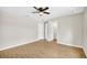 Bedroom with ceiling fan, wood-look floors and access to bathroom at 3120 Oleander Dr, Indian Lake Estates, FL 33855