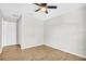 Bedroom with ceiling fan, closet and wood-look floors at 3120 Oleander Dr, Indian Lake Estates, FL 33855