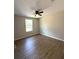 Bright and airy bedroom with wood-look flooring, a ceiling fan, and a large window at 3120 Oleander Dr, Indian Lake Estates, FL 33855