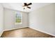 Bright bedroom with hardwood flooring, ceiling fan and a large window at 3120 Oleander Dr, Indian Lake Estates, FL 33855