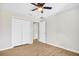 Bedroom features hardwood floors, a ceiling fan, and a spacious closet at 3120 Oleander Dr, Indian Lake Estates, FL 33855